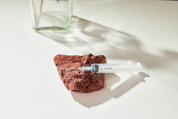 Medicine concept mockup with syringe on a delicate natural beige background and props. Health care,...