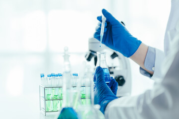 Medical research laboratory asian people male scientist working and analysing liquid biochemicals...