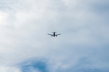 Fototapeta na wymiar the plane is flying against the blue sky
