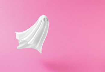 White ghost sheet costume against pastel pink background. Minimal Halloween scary concept. - obrazy, fototapety, plakaty