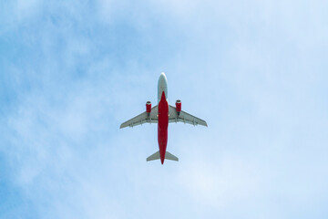 the plane is flying against the blue sky