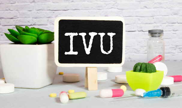 IVU. text on white paper, gray background, near pills and stethoscope in blue.