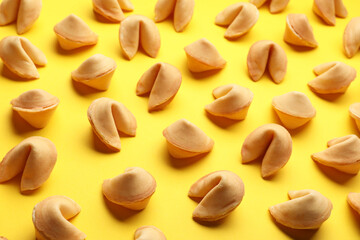 Fototapeta na wymiar Many tasty fortune cookies with predictions on yellow background