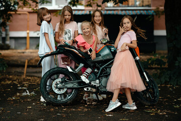 The children decided to take a picture with a motorcycle. A joint photo with a motorcycle....