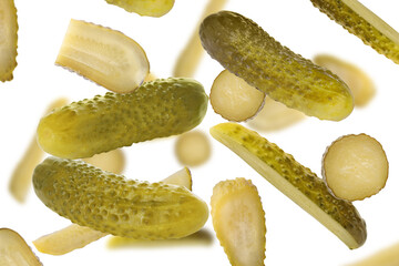 Tasty pickled cucumbers falling on white background