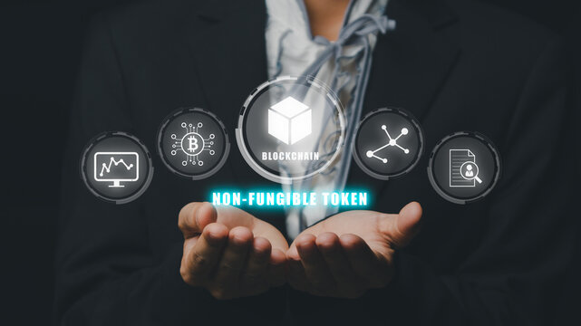 NFT token digital crypto art blockchain technology concept, Person hand holding virtual screen NFT icon background.