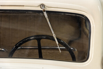 The windshield with wiper of the vintage car