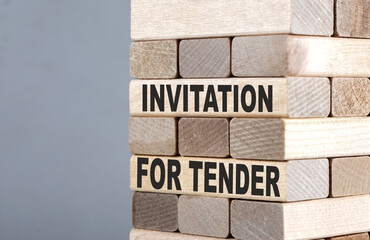 The text on the wooden blocks INVITATION FOR TENDER