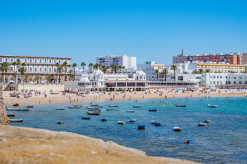 Intentional blurred wall overlooking La Caleta beach and architecture of the Our Lady de la Palma y del Real spa, Cádiz SPAIN © Liliana