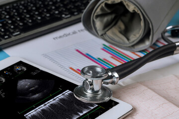 Using digital tablet, doctor checks results of echocardiography ultrasound the heart examination in order to prescribe a treatment that is effective for patient