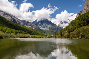 Fototapeta na wymiar Daocheng Yading National Park, blue sky with the mountains of Yading National Park in Daocheng , Sichuan, China, Tibet Autonomous prefecture