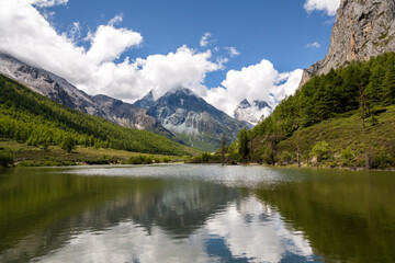 Plakat Horizontal image of the mountains reflection through the beautiful lake in Daocheng Yading, Sichuan, China