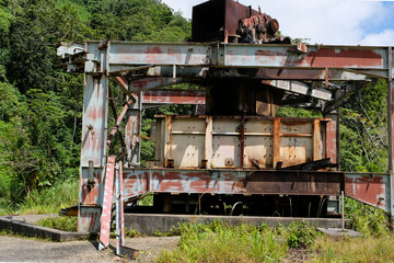 Abandoned mining machinery at closed Panguna mine town on the tropical island of Bougainville,...