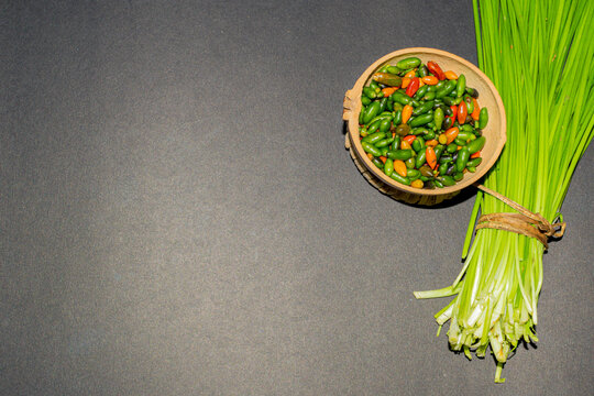 Chinese chives or garlic chives, along with chiltepin chili. Ingredients for the preparation of chiltepin chilli sauce