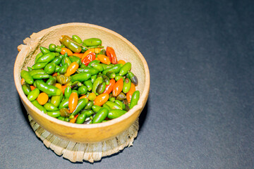 chiltepin chili presented in a traditional jicaro container