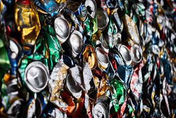 Pressed tin cans from drinks at recycling plant macro view