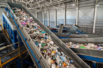 Trash transported by conveyor in recycling plant workshop