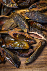 Betel nuts in a plate close-up top view on a black table