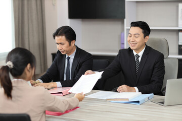 Human resources department managers sitting and interviewing female businesswoman applicant or candidate during job interview in modern office. Business recruitment concept