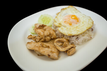 Top view of Fried chicken with garlic and pepper and omelet, focus selective