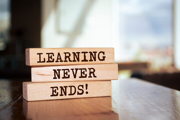 Wooden blocks with words 'Learning Never Ends'.
