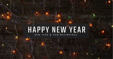 Image of happy new year and new beginnings text over colourful fairy lights on dark background