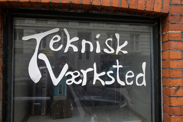 Copenhagen, Denmark A sign in Danish on a window says: Technical Workshop, or repair shop.