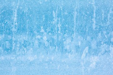 Fototapeta premium Texture of winter ice surface. Blue natural ice background