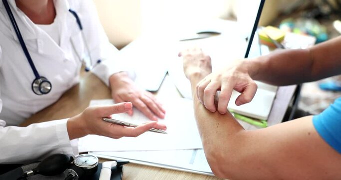 Male hands scratch due to dermatitis and itching sensation at doctor appointment