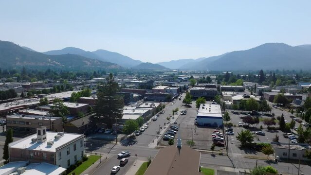 Moving aerial shot overlooking a busy street in downtown Grants Pass, Oregon.