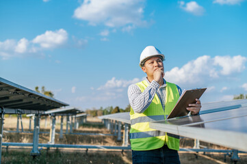 Young Asian technician man checking operation photovoltaic solar panel