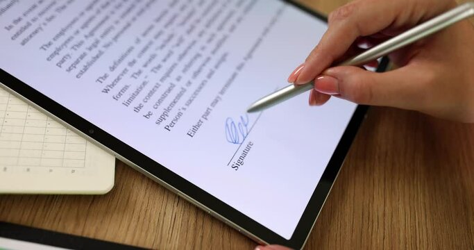 Woman hand holding stylus puts digital signature on document closeup