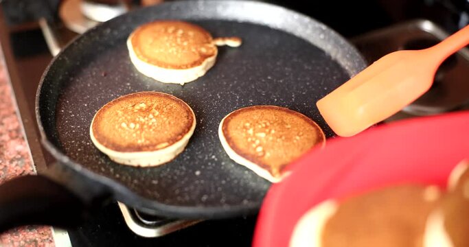 Fry pancakes in flat frying pan or skillet