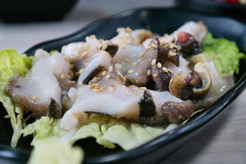 Fresh seafood sashimi served on a black plate