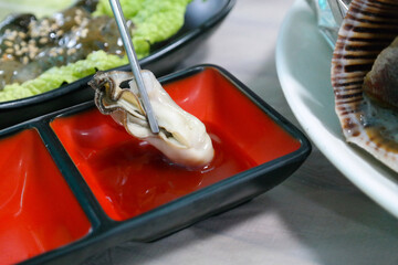 Steamed oysters dipped in red pepper paste