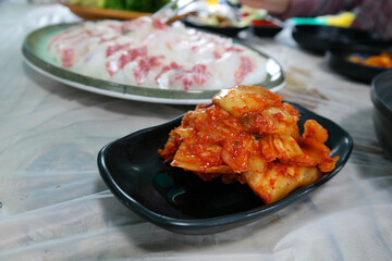 Korean style of eating fresh sashimi and aged kimchi together