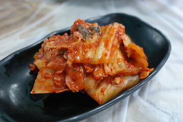 Aged kimchi served on a black plate