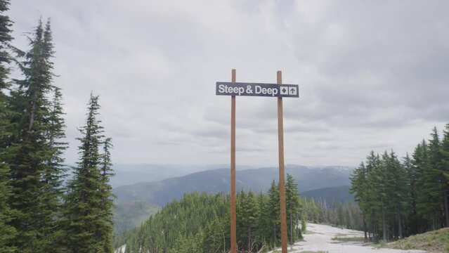 Slow motion of steep & deep named ski run sign at Idaho ski resort in winter