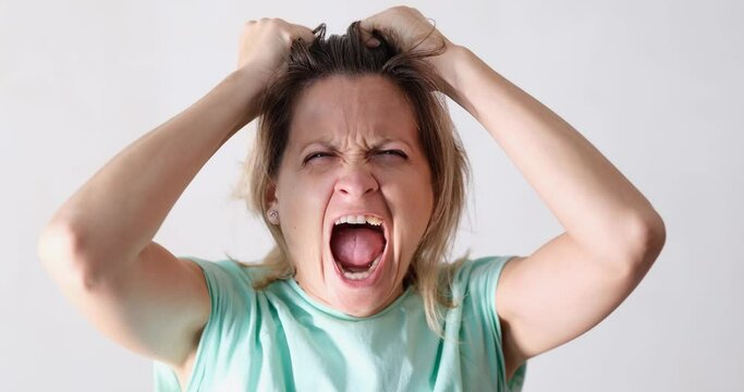 Stressed unhappy woman experiencing strong emotions, screaming and yelling
