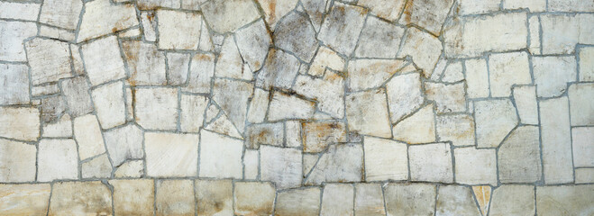Nature Stone wall texture for background and wallpaper. Abstract rough wall pattern panoramic dimensions.