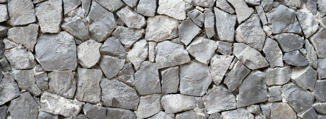 Nature Stone wall texture for background and wallpaper. Abstract rough wall pattern panoramic dimensions.