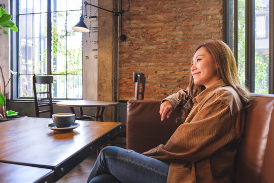 Portrait image of a beautiful young asian woman and a cup of coffee in cafe