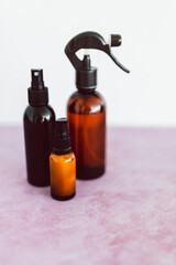 apothecary skincare bottles and scent spray on pink background, organic ingredients in skincare