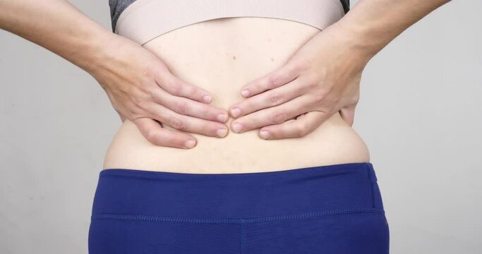 woman with back pain, hernia in the lower back. High quality 4k footage