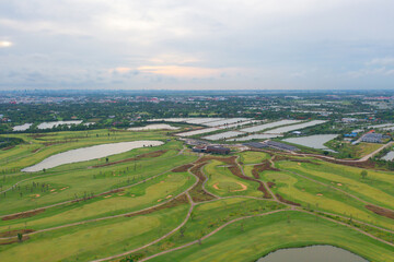 Fototapeta na wymiar Aerial view of Golf Course Club and hotel resort. Green natural garden park in sport and recreation concept.