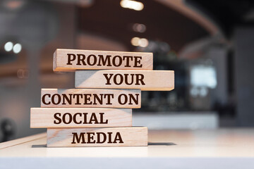 Wooden blocks with words 'Promote Your Content On Social Media'.
