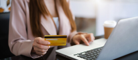Female use computers  to pay through credit card payment channels. Online shopping sit at the desk.