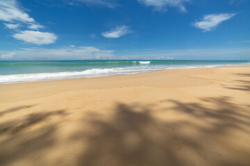 scenery white cloud in blue sky above long white beach..beautiful nature on the beach..smooth waves from green sea background.