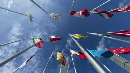 Flags of the World waving in the wind on a background blue sky and white clouds. flags of many countries.  for political, international trade, relationship concepts