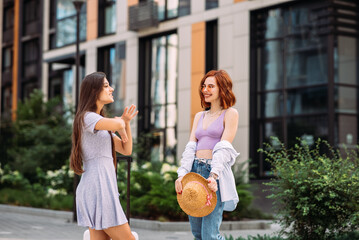 Two beautiful women talking and standing outdoors